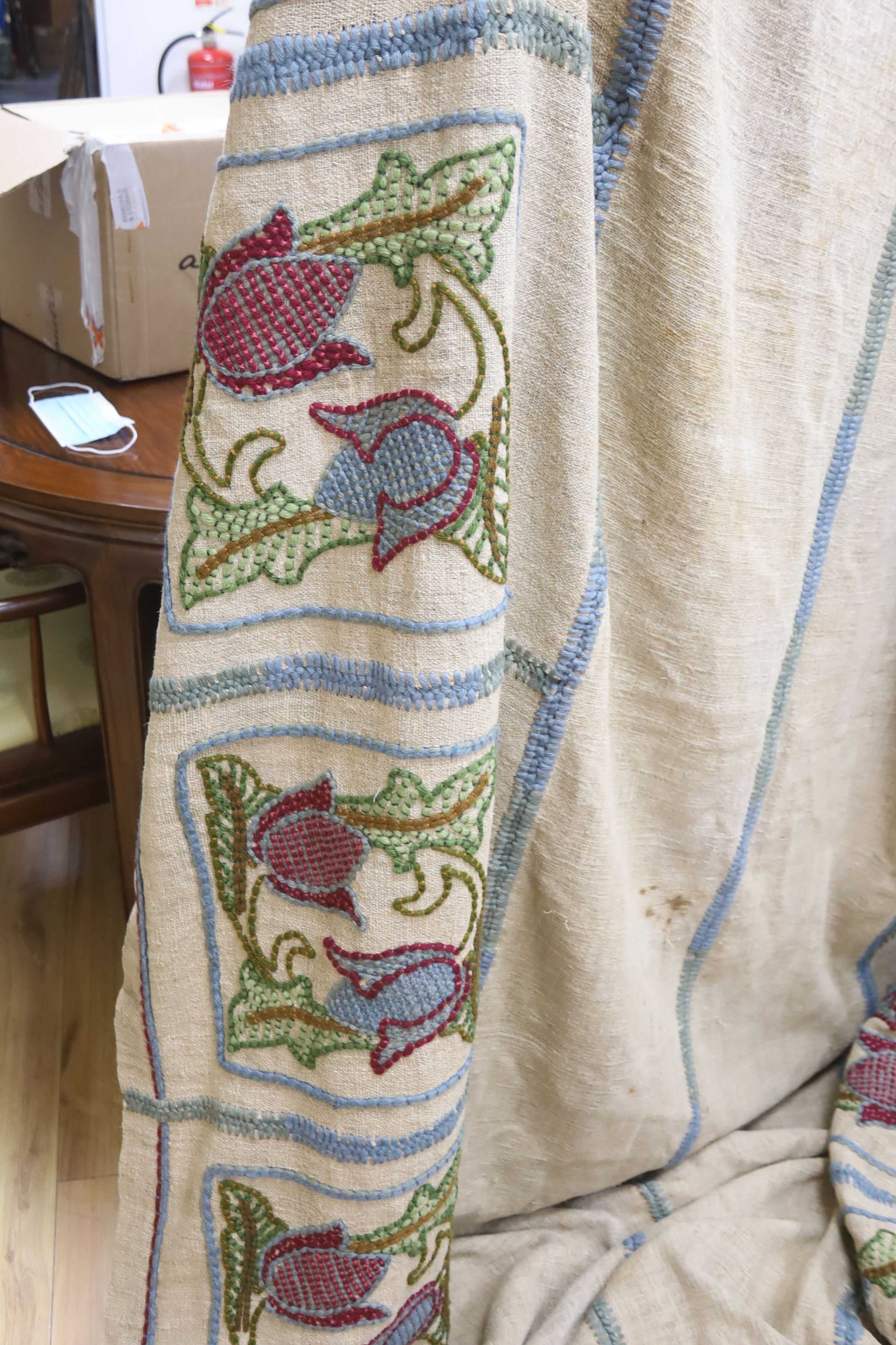 An Arts and Crafts embroidered on hessian table cover with fitted sides, decorated crewelwork embroidery